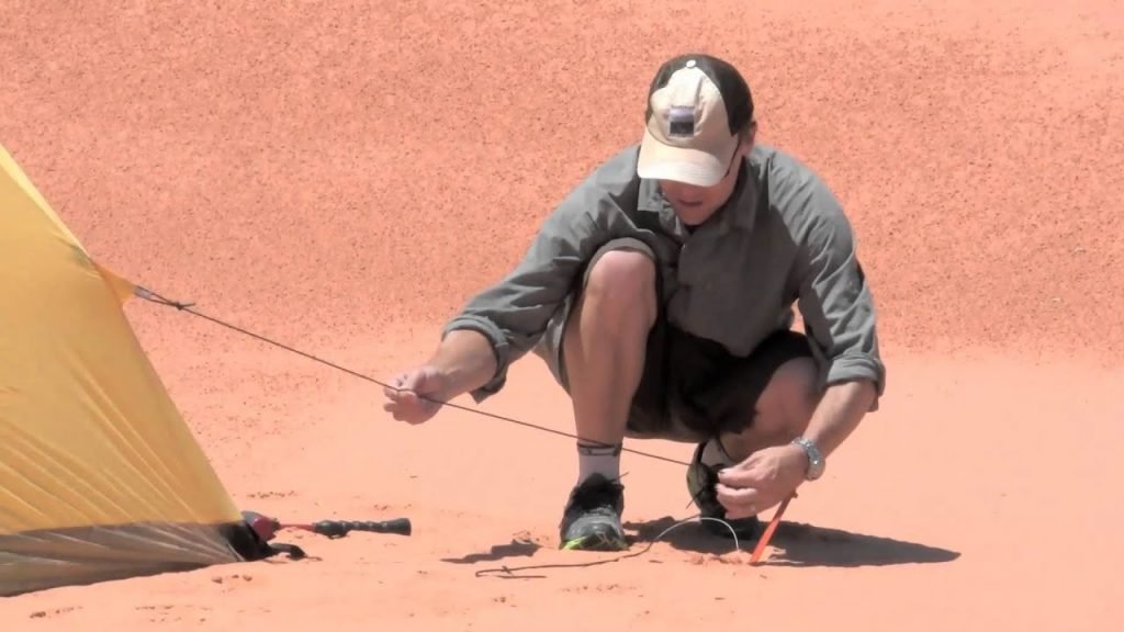 Inserting Tent Stakes in sand