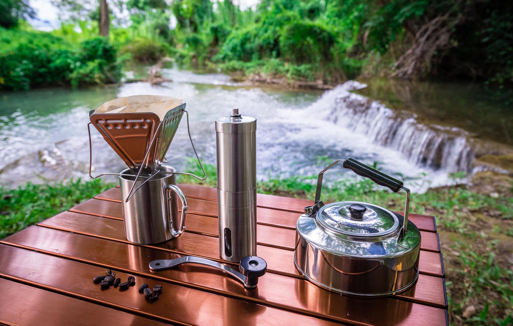 Coffee drip while camping near waterfall