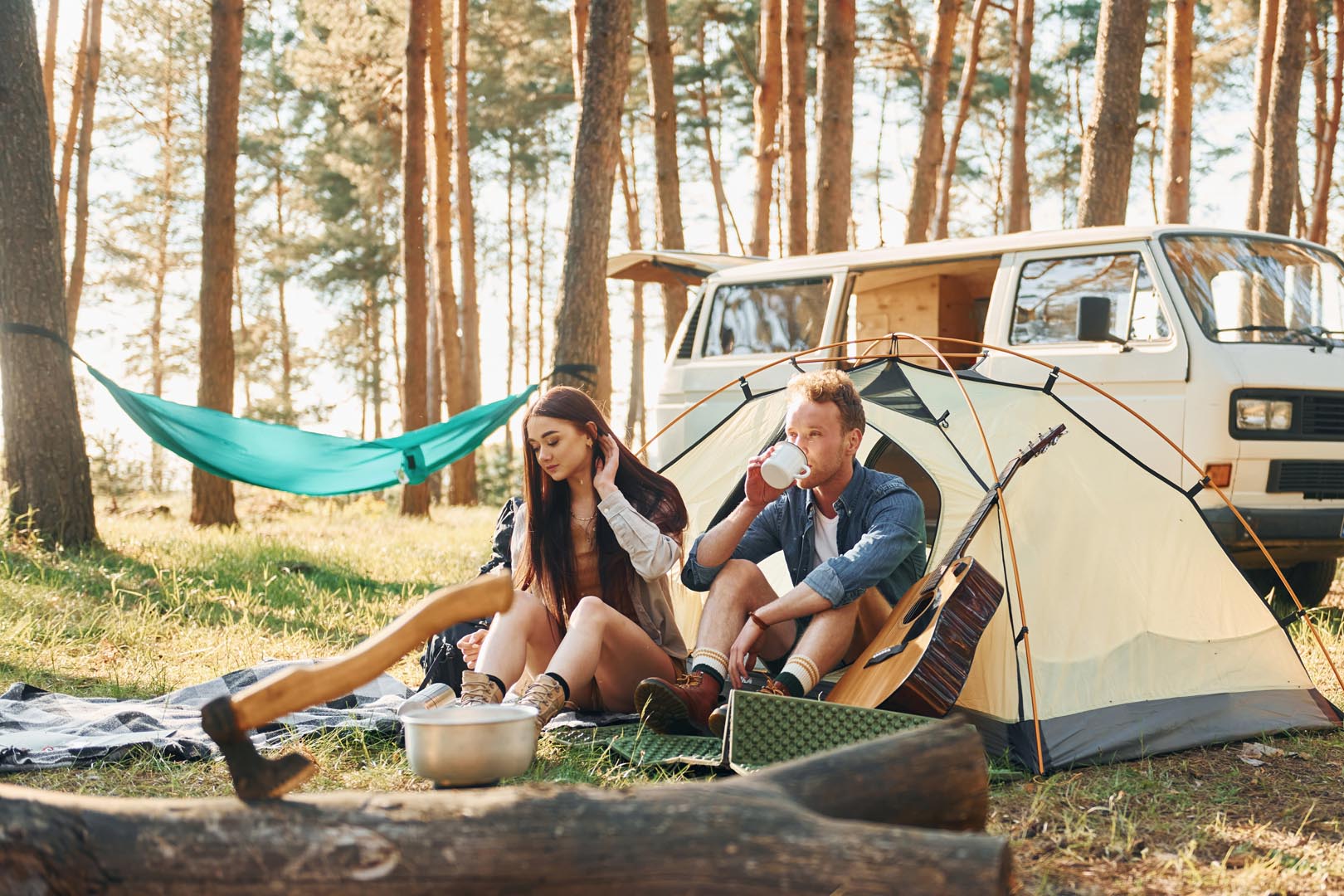 Evening time young couple is traveling forest together