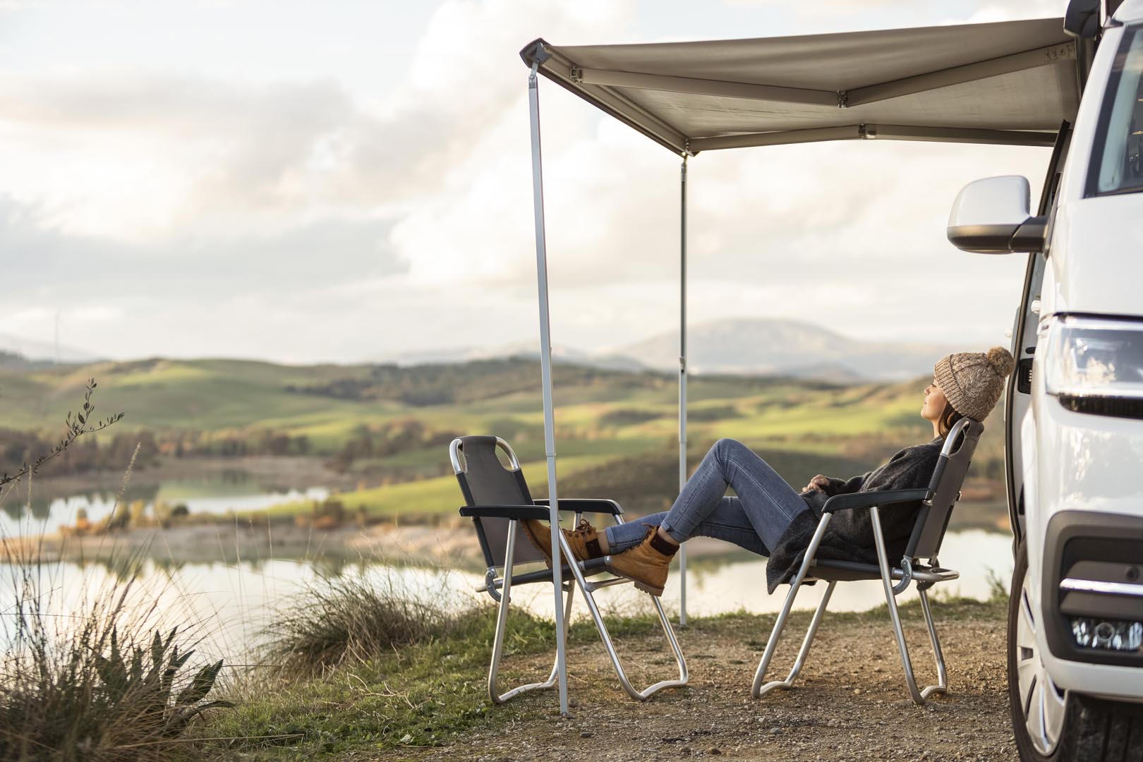 Front view road trip car lake with woman relaxing