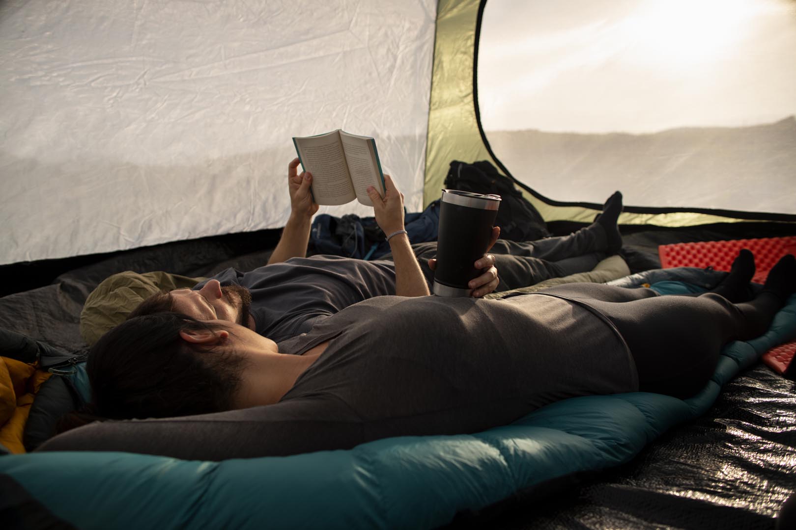 Full shot adventurous couple bivouacking
