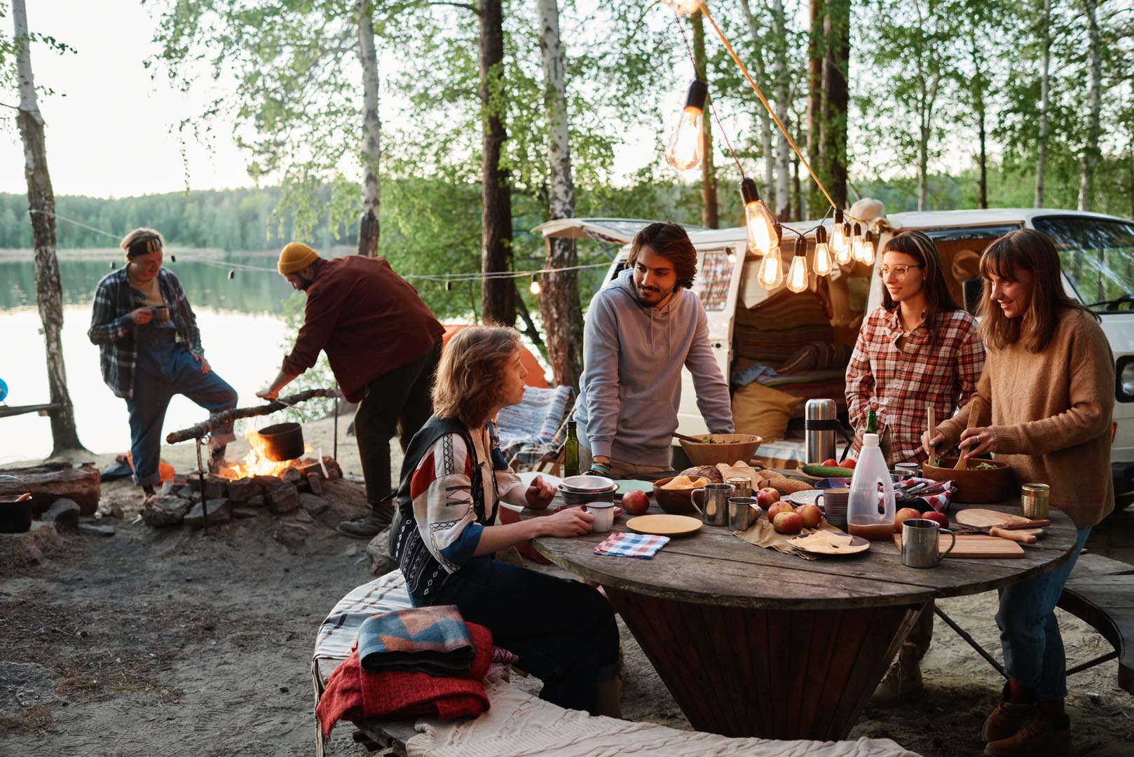 Group friends eating talking together picnic forest
