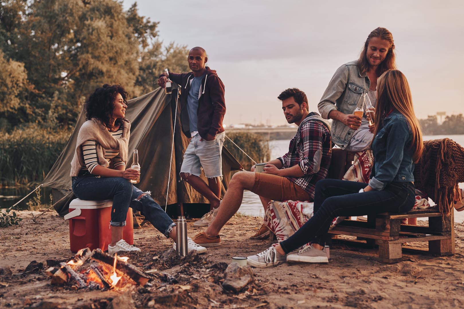 Happy travel together group young people casual wear smiling drinking beer