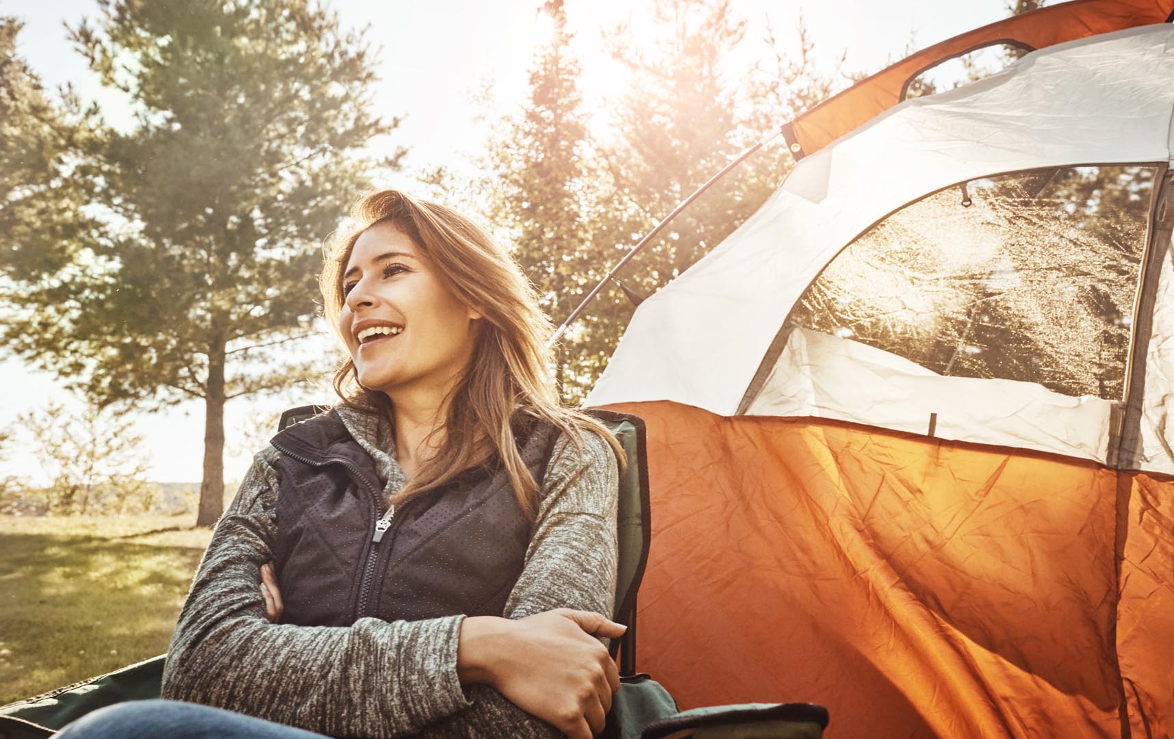 Happy woman laughing sunshine with tent camping holiday outdoor weekend nature female