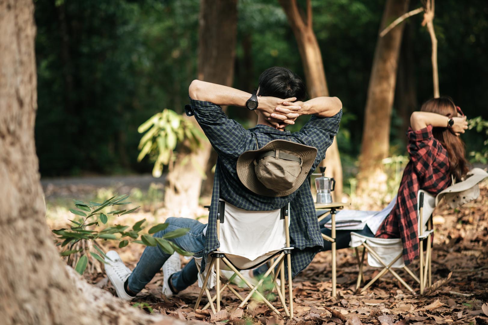 Rear view young asian teenager couple have relax time with camping trip