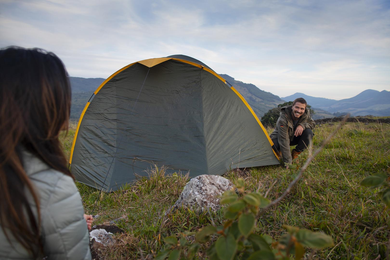Side view adventurous couple bivouacking