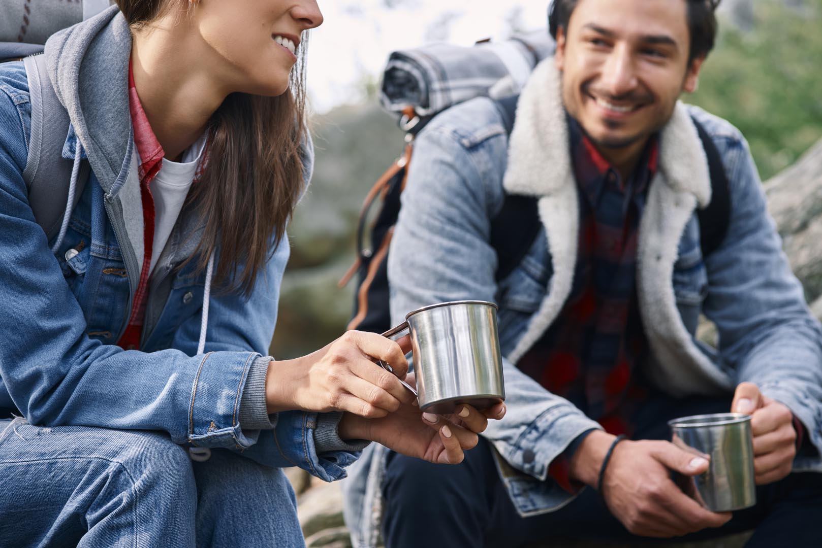 Two backpackers drinking coffee talking