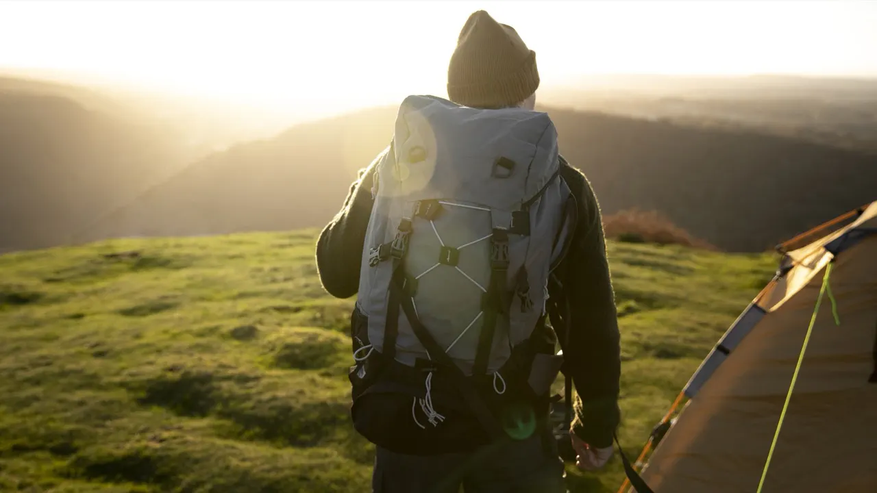Walking back to camp at sunrise with a packed backpack